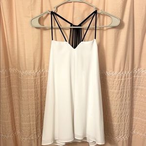 Elegant white tank top with detailed black straps!